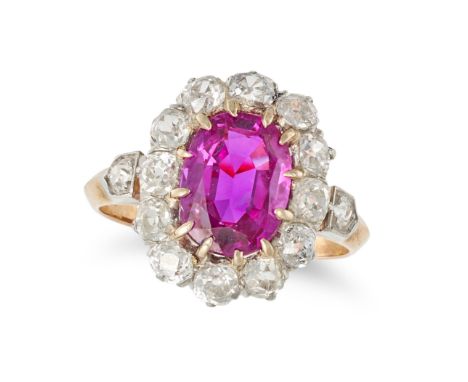 AN ANTIQUE BURMA NO HEAT RUBY AND DIAMOND CLUSTER RING set with an oval cut ruby of 3.24 carats in a cluster of old cut diamo