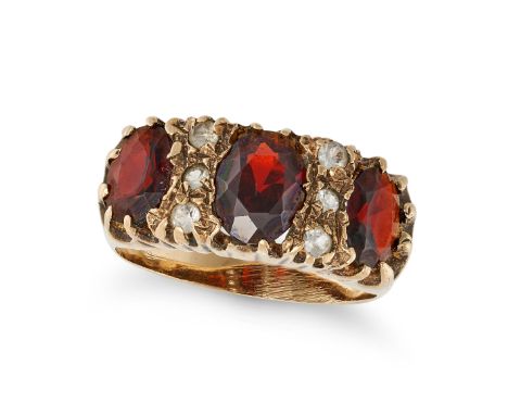 A VINTAGE GARNET AND DIAMOND RING in 9ct yellow gold, set with three oval cut garnets accented by trios of round cut diamonds