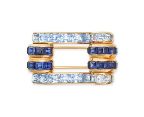 A RETRO SYNTHETIC SAPPHIRE AND BLUE TOPAZ BROOCH in scrolling form set with rows of rectangular step cut synthetic sapphires 