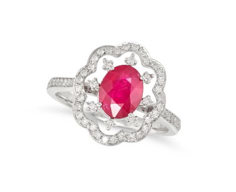 A RUBY AND DIAMOND CLUSTER RING in 18ct white gold, set with an oval cut ruby of 1.42 carats in an openwork border set with r
