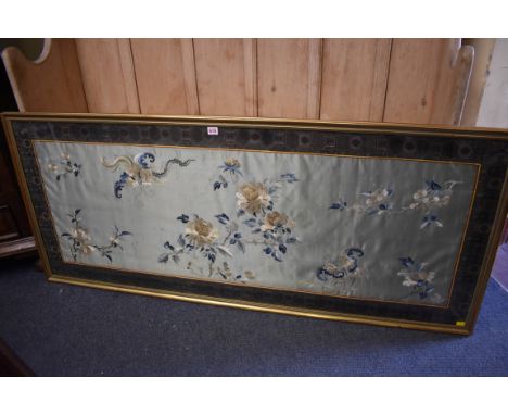 A large Chinese silk embroidered panel, decorated with butterflies and floral sprigs, 49.5 x 143cm.&nbsp; 