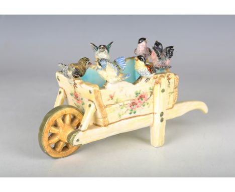 A Delphin Massier Vallauris majolica pottery planter, late 19th century, modelled as a wheelbarrow surmounted by six birds, b