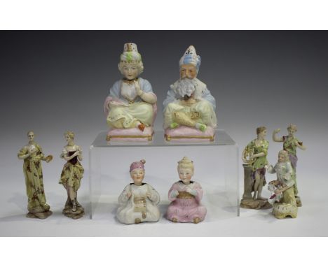 A pair of Continental bisque porcelain nodding head figures, circa 1900, seated cross-legged on pink cushions, height 14cm, t