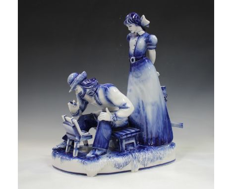 A large Gzhel Russian blue and white porcelain figure group, circa 2004, modelled as a standing female watching a seated arti