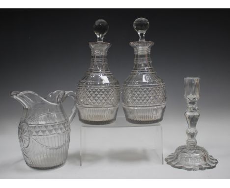A pair of mallet shaped cut glass decanters and matched stoppers, 19th century, each with a band of hobnail diamonds above fl