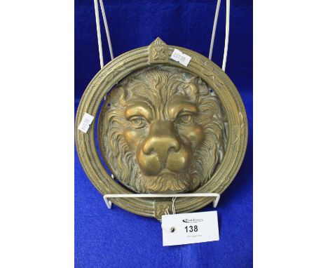 Brass door knocker in the form of a lion mask.