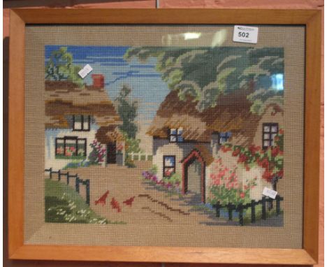 Framed tapestry study of a thatched cottage.