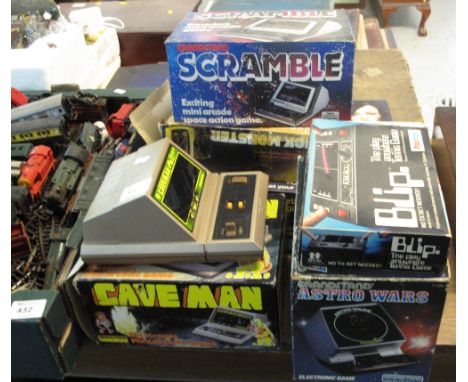 Six vintage electronic and battery operated games, hand held games in original boxes to include Cave man, Scramble, Blip, Ast
