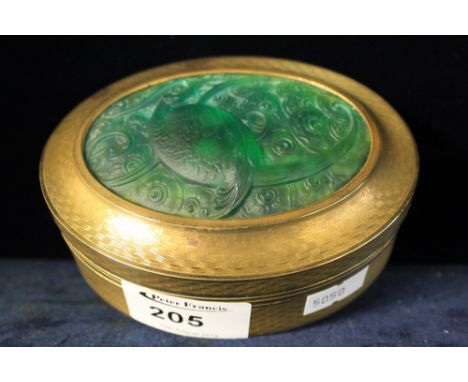 Gilt metal engine turned oval box, the lid decorated with green art glass panel of a fantastic bird, signed R Robert. CONDITI