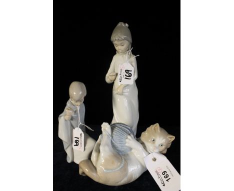 Nao porcelain cat and ball of wool, Nao figure of a young girl with dog and Lladro figure of a young boy.  (3)