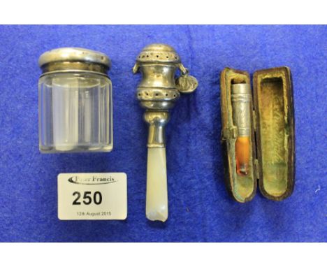 Silver and mother of pearl babies rattle, silver topped glass dressing table jar, cased silver cigarette holder.
