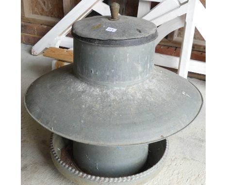 A zinc chicken hopper