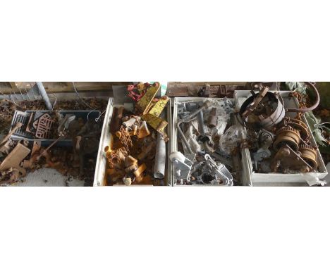 A pallet containing various cast iron items, including pulleys, drain covers, tractor weights, scrap metal etc