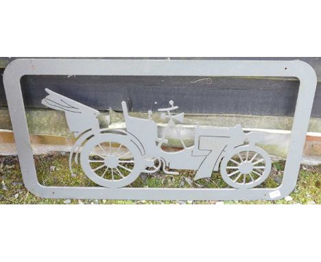 A cut cast iron wall plaque / sign depicting a vintage car, being grey painted, 45 x 84cm 