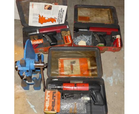 A boxed Hilti DX400 direct force fastening tool; together with two other boxed Hilti power tools; and a Clarke strong arm pun