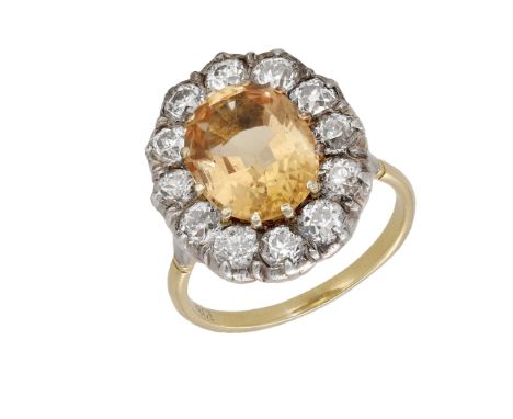 A golden topaz and diamond cluster ring, converted from a 19th century jewel, the mixed-cut topaz claw set within a surround 