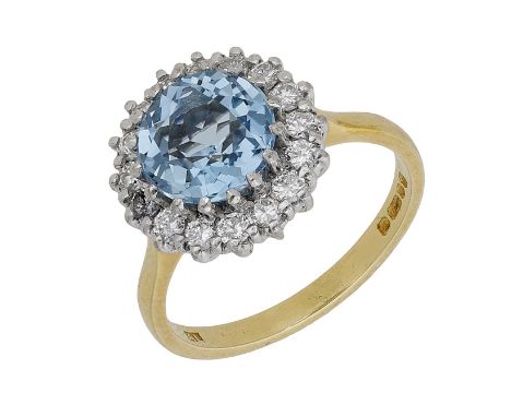 An aquamarine and diamond cluster ring, 1978, the circular-cut aquamarine claw-set within a surround of brilliant-cut diamond
