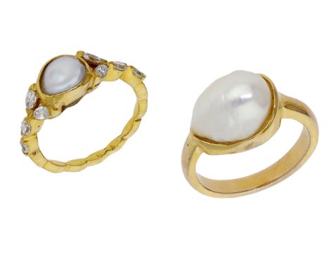 Two dress rings, the first set with a cultured freshwater pearl (drilled) between marquise-cut diamond shoulders, the second 