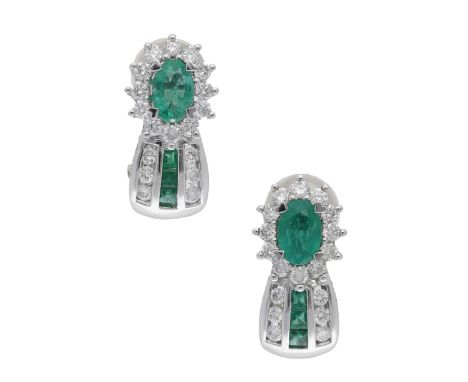 A pair of emerald and diamond cluster ear clips, channel-set with brilliant-cut diamonds and calibré-cut emeralds, beneath an