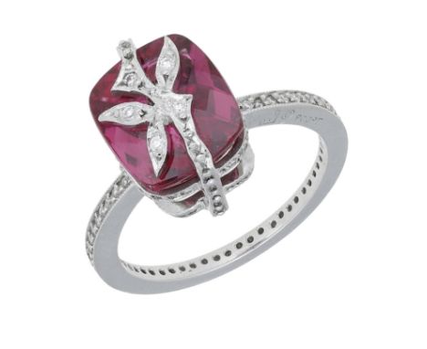 A tourmaline and diamond dress ring, the cushion-shaped pink tourmaline set beneath a foliate motif with brilliant-cut diamon