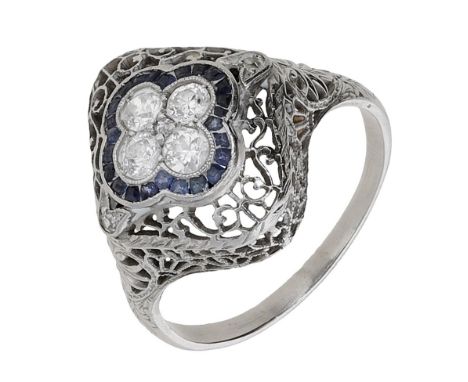 A sapphire and diamond ring, the pierced cartouche set with a quatrefoil of brilliant-cut diamonds within a surround of calib