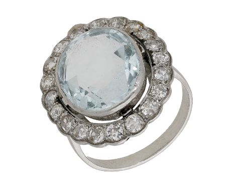 An aquamarine and diamond cluster ring, the oval-cut aquamarine set within a surround of old brilliant-cut diamonds, total di