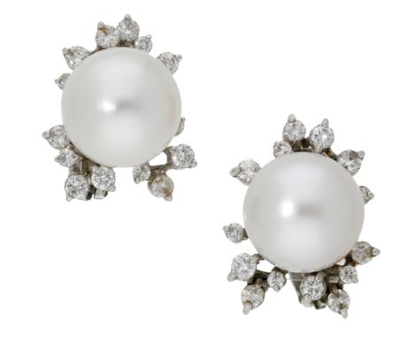 A pair of cultured pearl and diamond ear clips, the cultured pearls, measuring approximately 13.5mm, set within an asymmetric