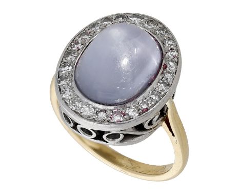 A star sapphire and diamond cluster ring, the sugarloaf star sapphire set within a surround of single-cut diamonds, mounted i