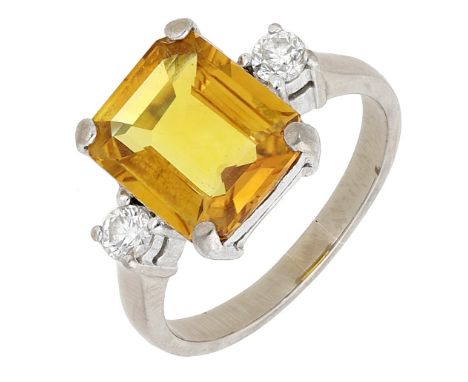 A yellow sapphire and diamond ring, the step-cut sapphire between brilliant-cut diamond shoulders, stamped ‘750’, ring size Q