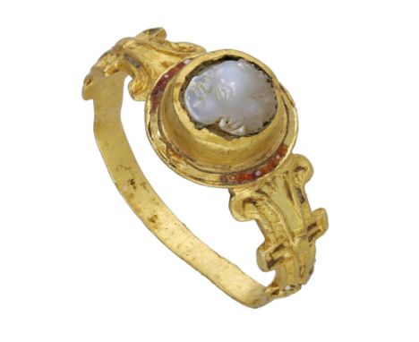 A 16th century Elizabethan gold ring set, the circular bezel set with a high relief white chalcedony cameo carved to depict t