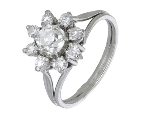 A diamond flowerhead cluster ring, French, set with old brilliant and brilliant-cut diamonds, between trifurcated shoulders, 