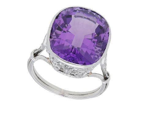 An amethyst and diamond dress ring, the cushion-cut amethyst within an openwork basket setting of scroll design set with rose