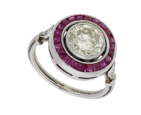 An Art Deco ruby and diamond target ring, the transitional-cut diamond set within a surround of calibré-cut rubies, to diamon