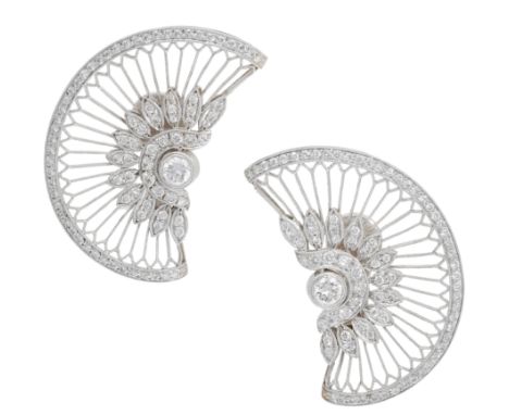 A pair of diamond ear clips by Adler, the knifewire fans with a brilliant-cut diamond cluster to the centre and with a simila