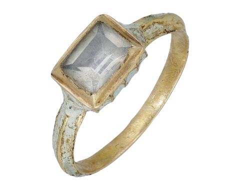 An early 17th century gold, enamel and rock crystal ring, the central table-cut rock crystal set within a rectangular box bez