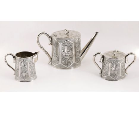 A Chinese export silver three piece tea service by Kwan Wo, comprising tea pot, cream jug and twin-handled sugar basin and co