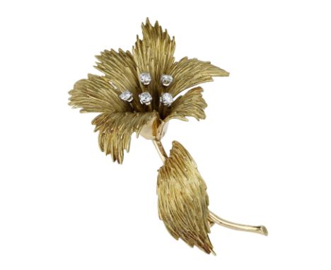 A diamond flower brooch, French, circa 1970, with textured petals and leaf, the stamen set with brilliant-cut diamonds, Frenc