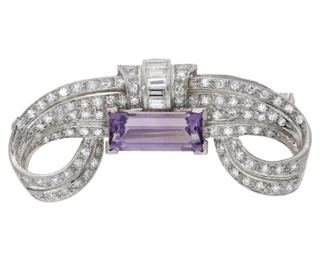 A mid 20th century amethyst and diamond brooch, of Art Deco style, the pierced volutes set throughout with baguette and singl
