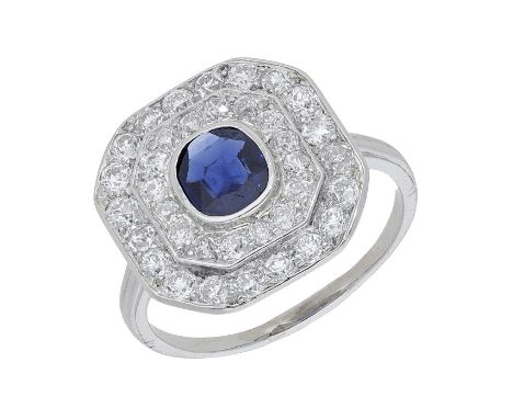 A sapphire and diamond plaque ring, the cushion-shaped sapphire in a stepped two-row surround of old brilliant-cut diamonds, 