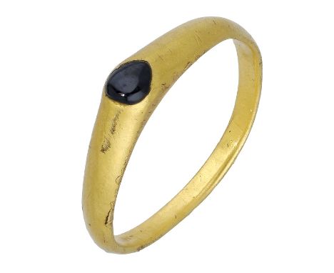 A Medieval gold sapphire stirrup ring, late 13th/early 14th century, the hoop of D-shaped cross-section, with raised triangul