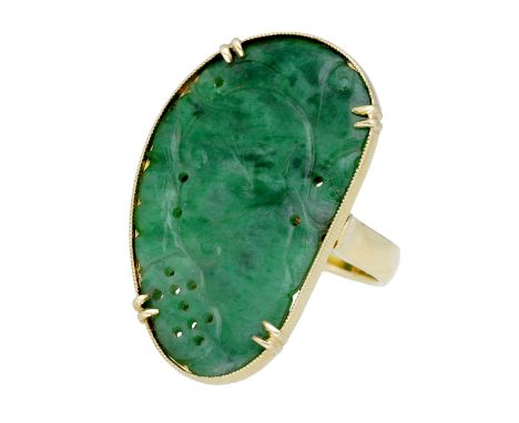 A jade panel ring, the pierced jade panel with carved foliate decoration, set to a plain polish band, (jade untested), stampe