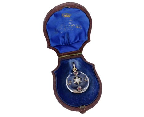 A late 19th century gem-set rock crystal pendant, the circular polished rock crystal pendant applied with a star-shaped clust