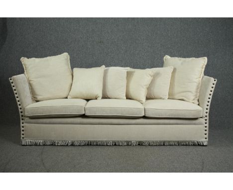 A Knole sofa, fully re-upholstered and covered with a matching set of cushions. H.80 W.250 D.75cm. 