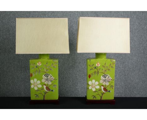 A pair of large Chinese ceramic lamps in a light olive green glaze and hand-painted birds of paradise. With matching square s