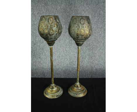 A pair of modern candle holders. Light metal in a painted distressed finish with two glass candle holders inside of each. H.4