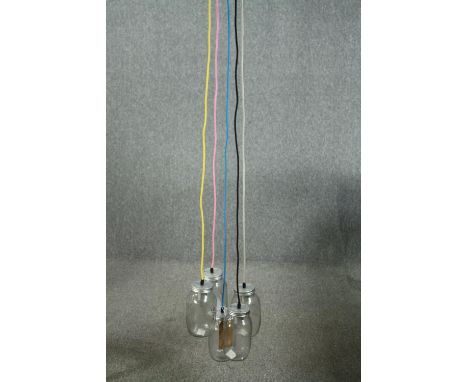 A ceiling light made up of a cluster of jam jars with coloured cable. L.147cm. Proceeds from this lot will be donated to the 