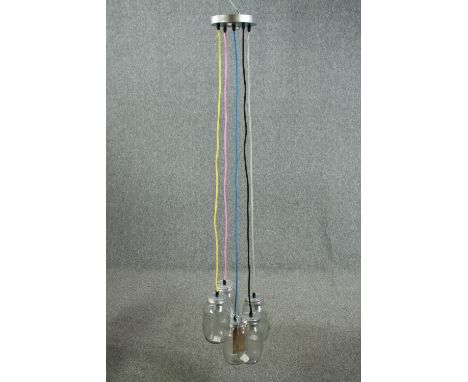 A ceiling light made up of a cluster of jam jars with coloured cable. L.147cm. Proceeds from this lot will be donated to the 