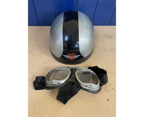 A Davida Moto pudding basin helmet, silver with a black stripe, and a pair of goggles 