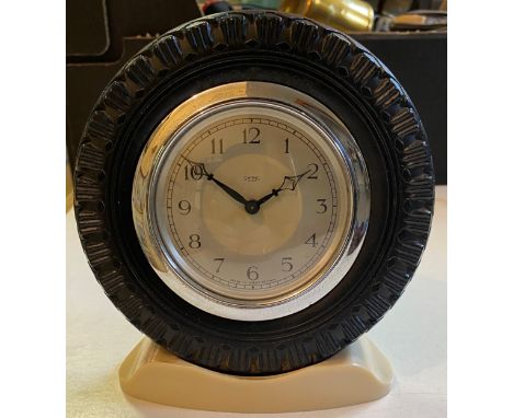 A showroom type clock, the Smiths clock with Arabic numerals, in a Good Year tyre surround, on a stand, 16 cm high 