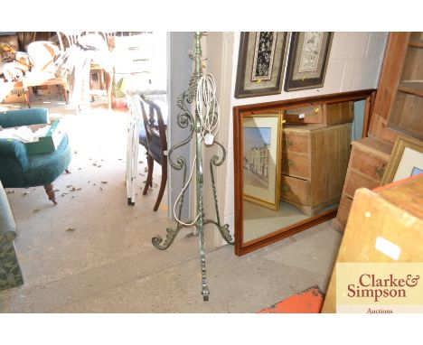 A green painted wrought metal adjustable lamp standard